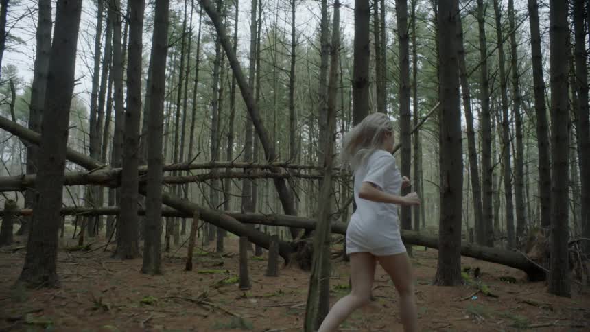A woman running through the woods