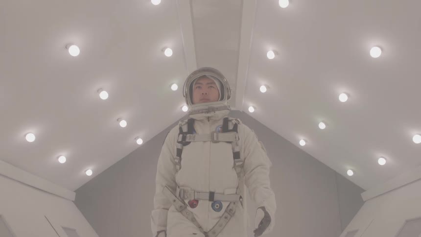 The astronaut walks through the corridor