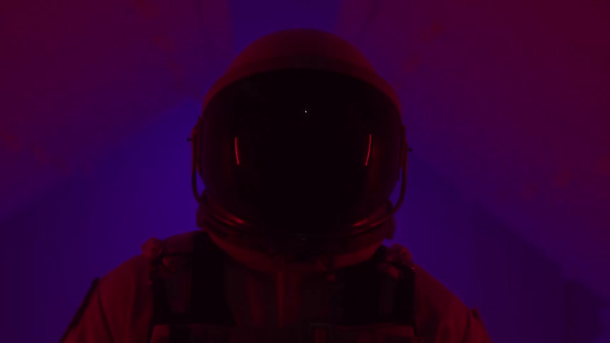 Person in spacesuit in a room with lights