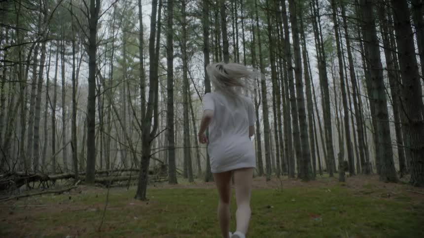 A woman is racing through the forest