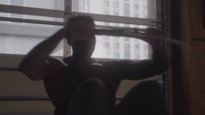 Man trains on rowing machine inside a gym