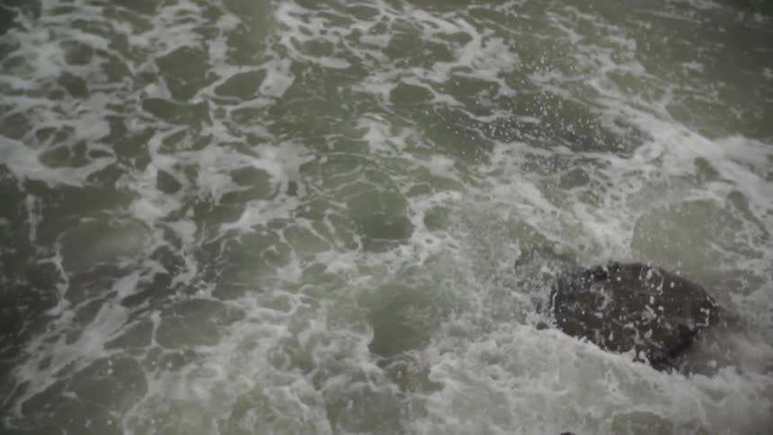 Water crashes on boulders and rocks
