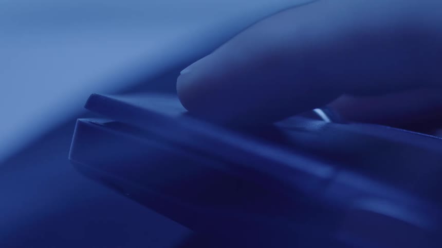 Extreme close up of a person using a computer mouse in a room