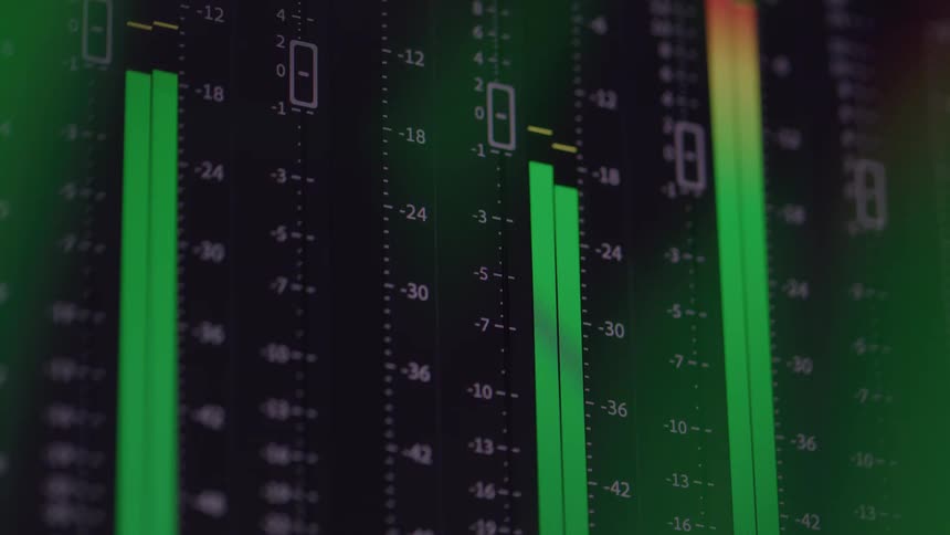 Close up of an electronic screen displaying various green fluctuating sound decibel bars