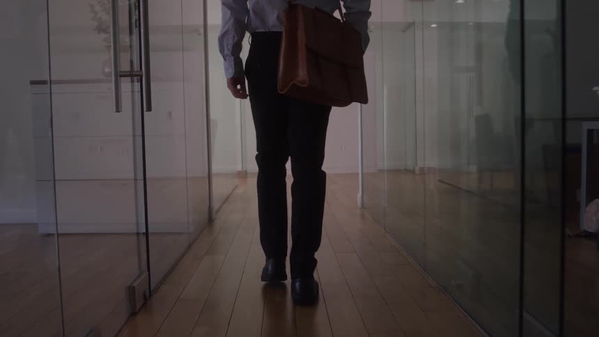 The worker heads out of the office down the hall