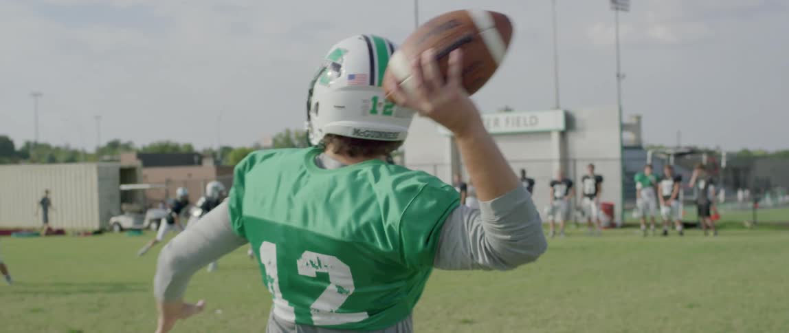 American football player throwing the ball on the field