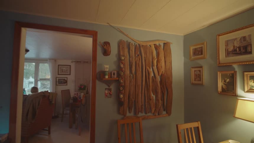 House dining area with a series of frames hanging on the wall
