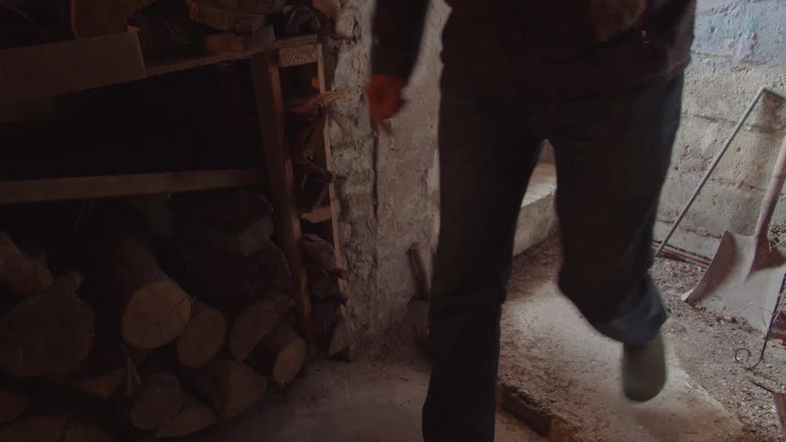 A person walks down into their basement