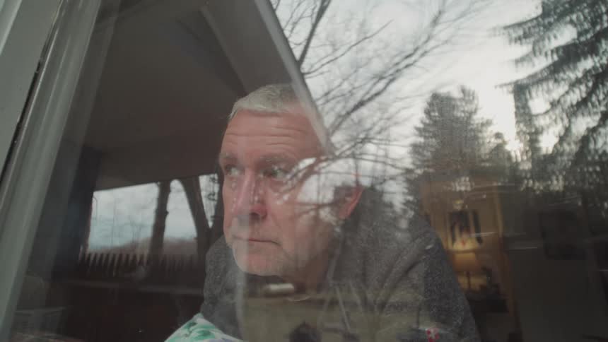 Man watching through a window