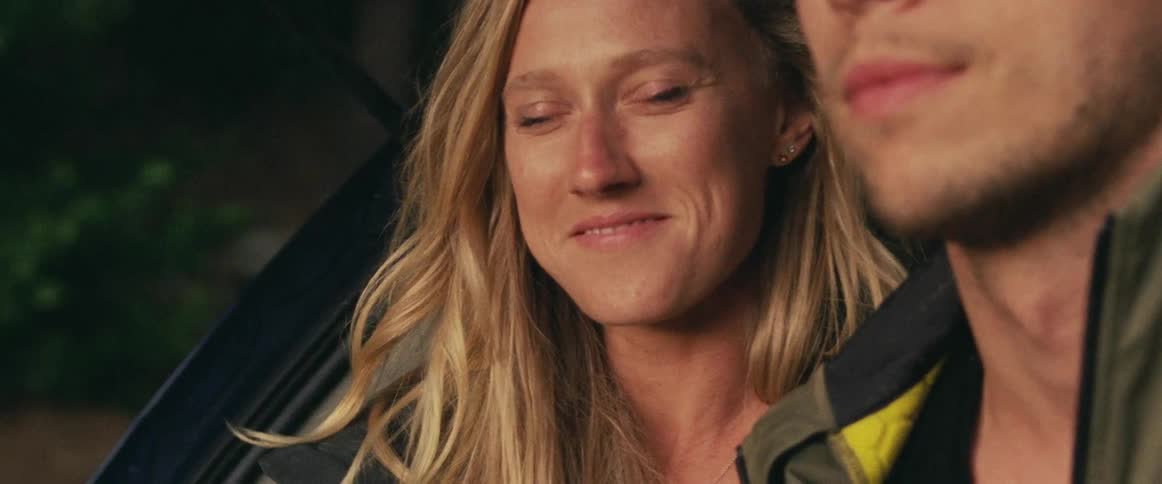 A woman looks to a man and smiles