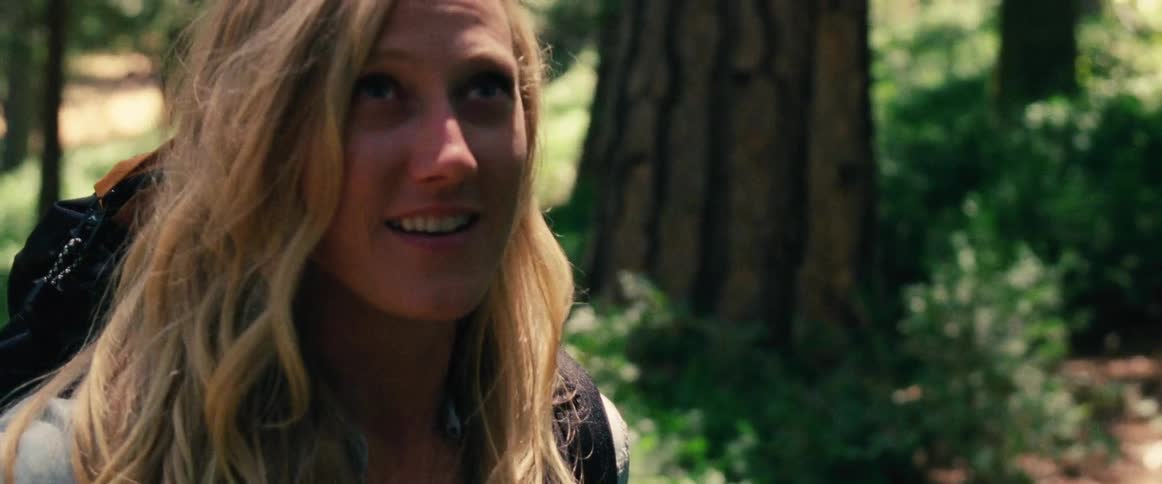 A woman smiles and claps her hands
