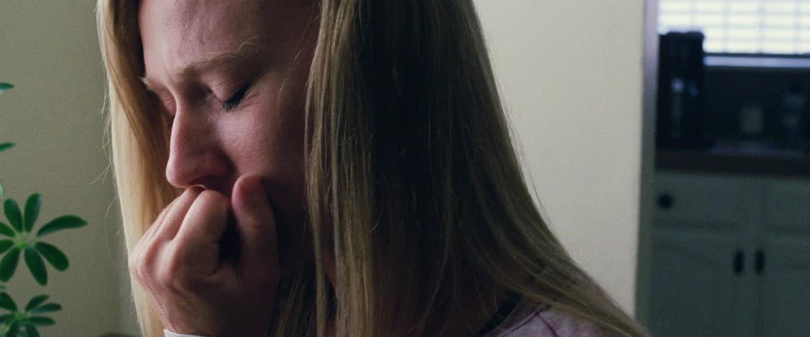 A woman looks down examining something