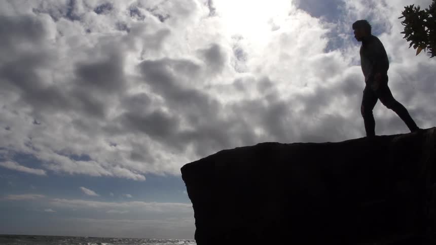 Waves and a cliff with clouds