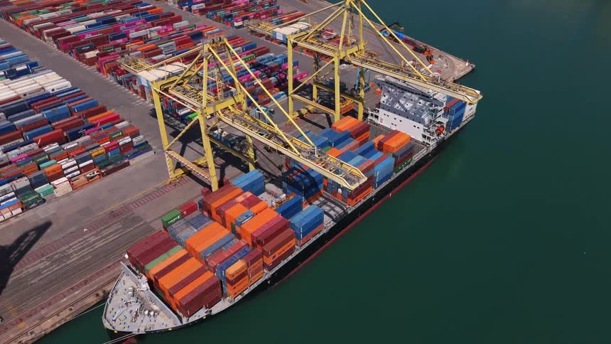 Cargo ship being loaded with containers at the port