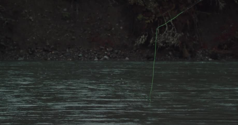 A fishing pole throwing a line on a river