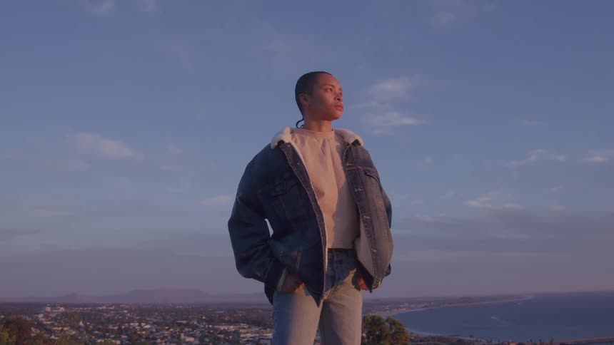 Woman in denim outfit in an elevated setting in the late afternoon