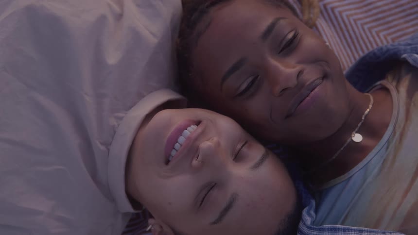 A couple lay together outside