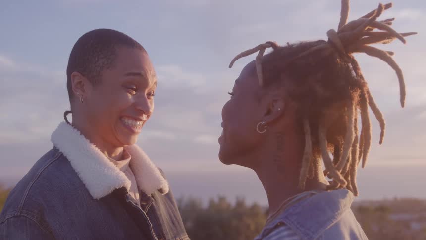 Two smiling women talking