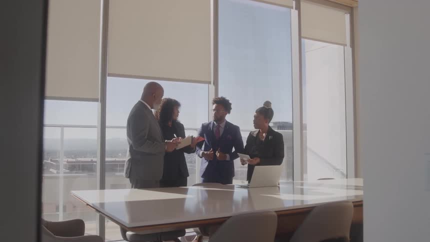 Team members are talking in the conference room