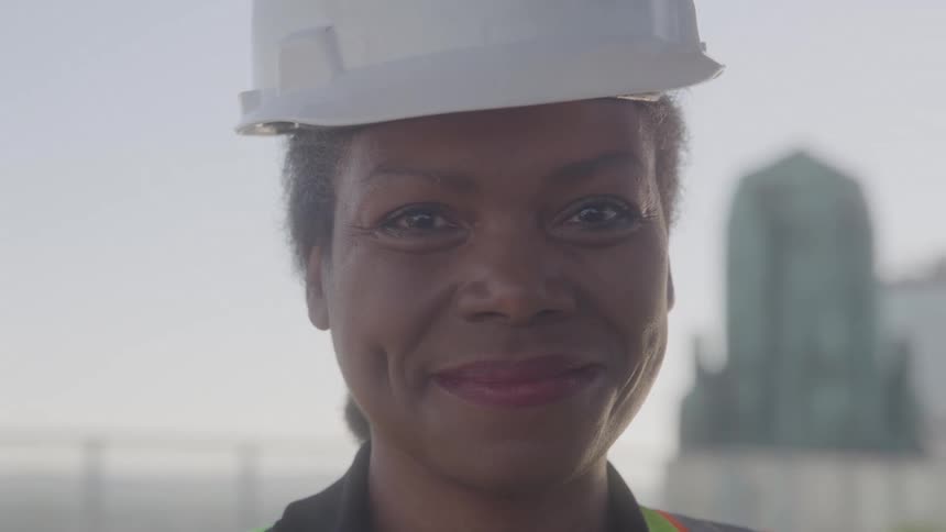 Close up portrait of a young black female construction worker during daytime