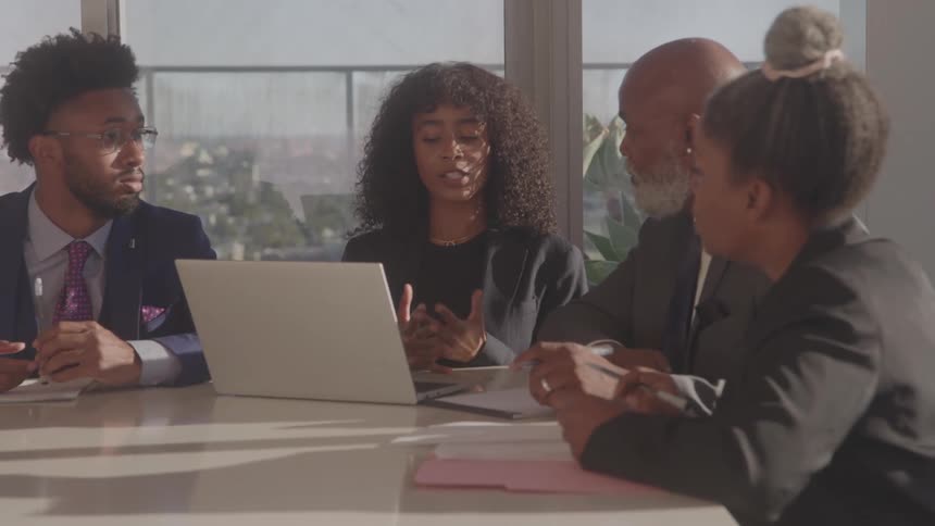 People are having a conversation at a meeting