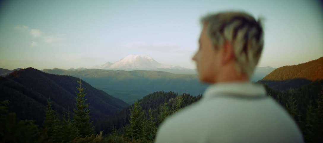 Man overlooking a mountainous landscape