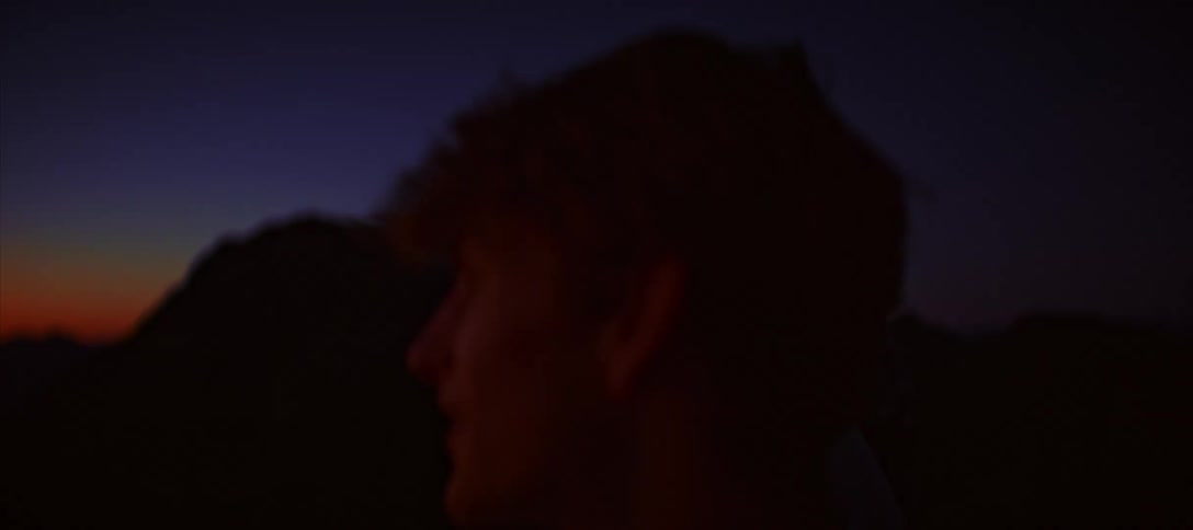 Three teenagers watch the sunset