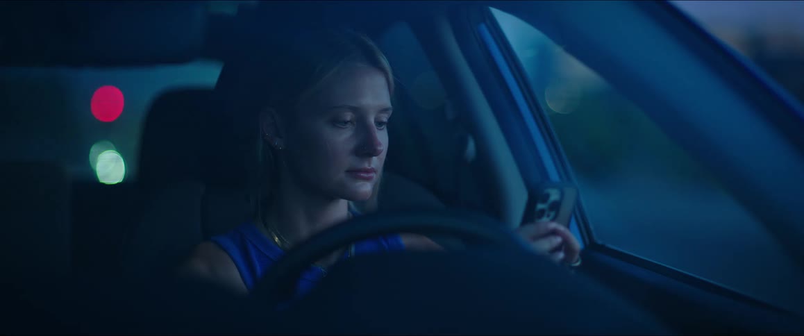 Woman interacting with smartphone while inside car
