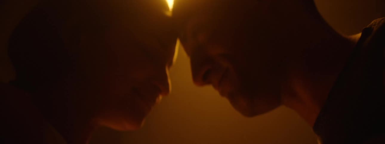 A couple touch heads while talking