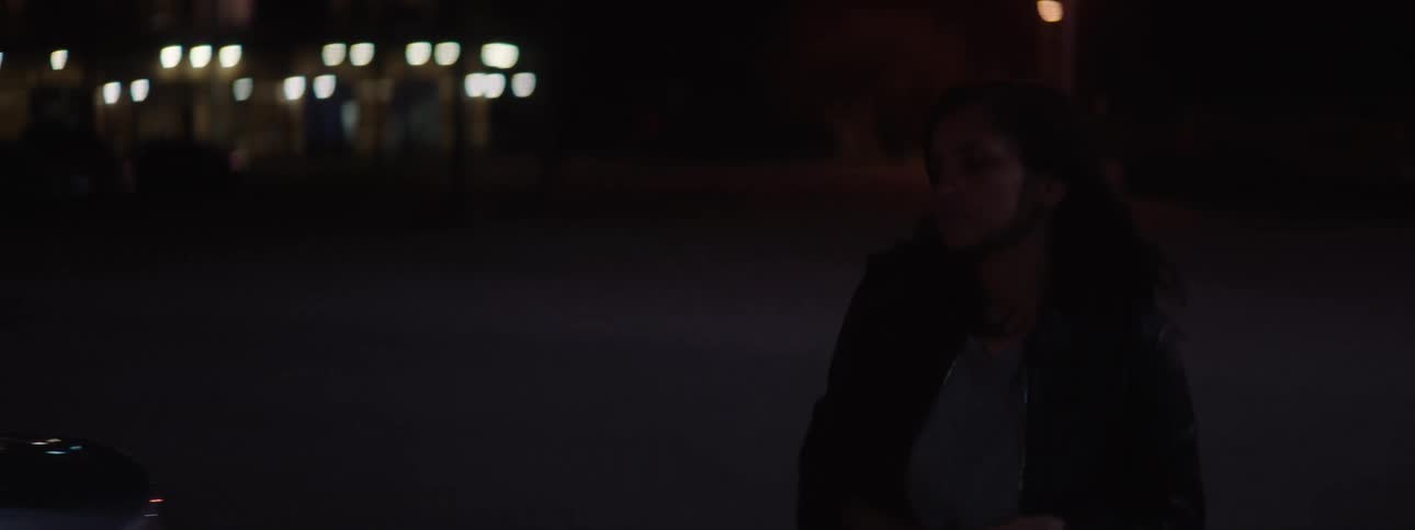 The woman walks over to her car and gets in