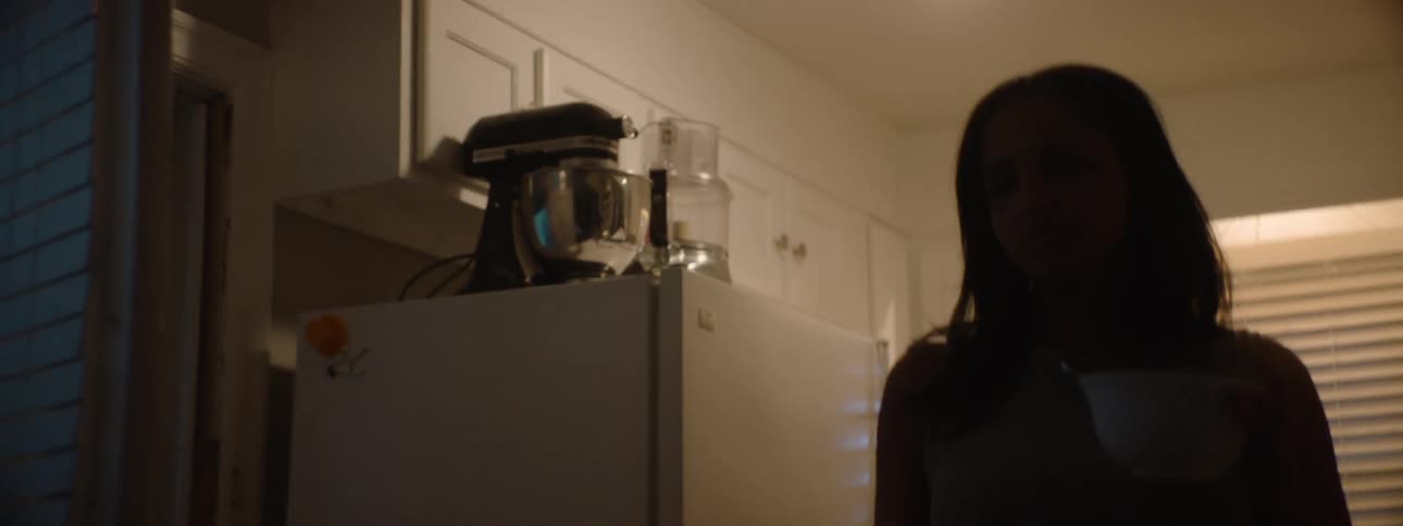 Woman holds a bowl and goes to the table