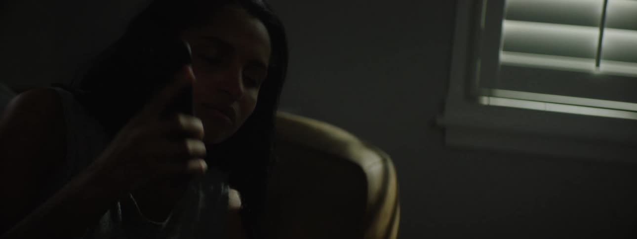 Woman lying down answering a phone call and getting up