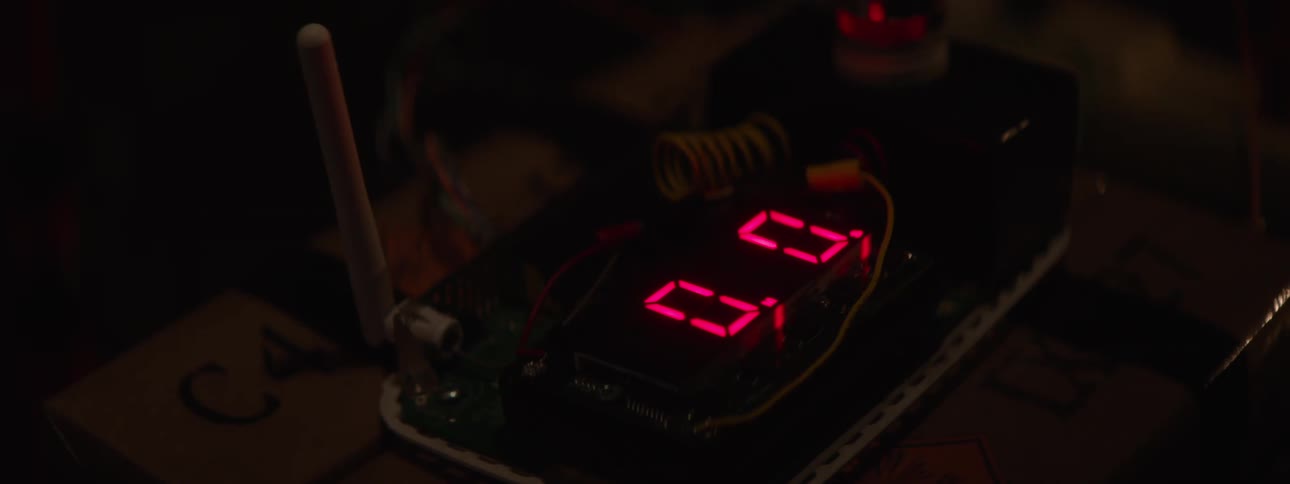 Person resets the led display of an electronic machine standing on a cardboard box