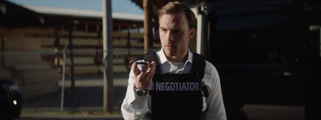 Police officer negotiating in a tactical operation on the phone call