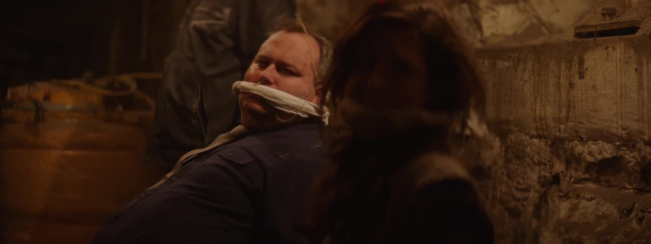 Three people with gag in their mouth in a captivity setting hostage situation