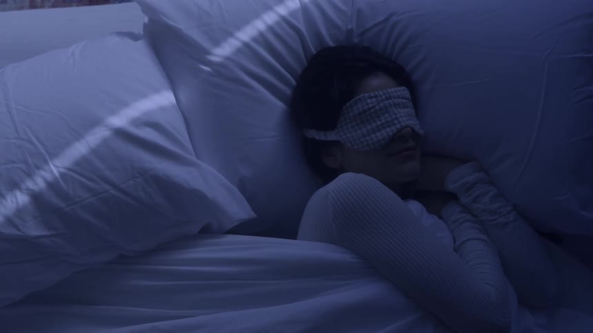 Woman with eye patch sleeping