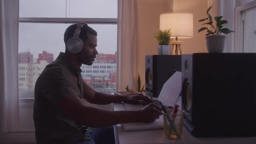 The man is nodding while using his laptop