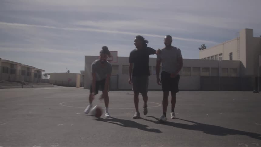 Three men are playing basketball