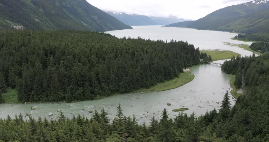 River surrounded by trees and mountains outdoors during day time