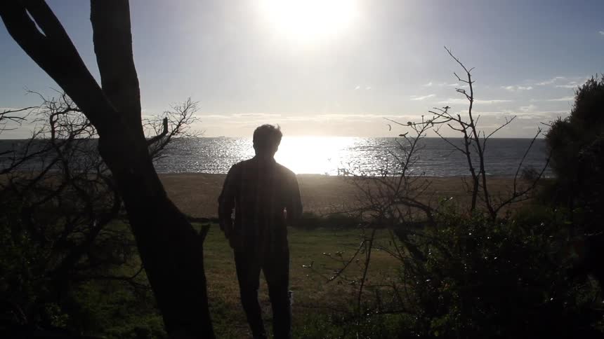 Man walking towards the water