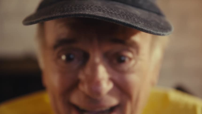 Euphoric and cheerful elderly man using a tablet