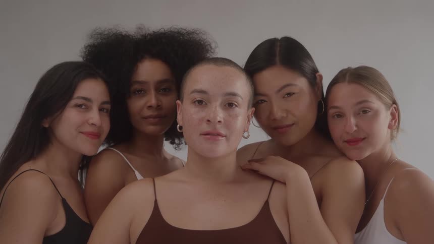 A portrait of five young women who are all posing together