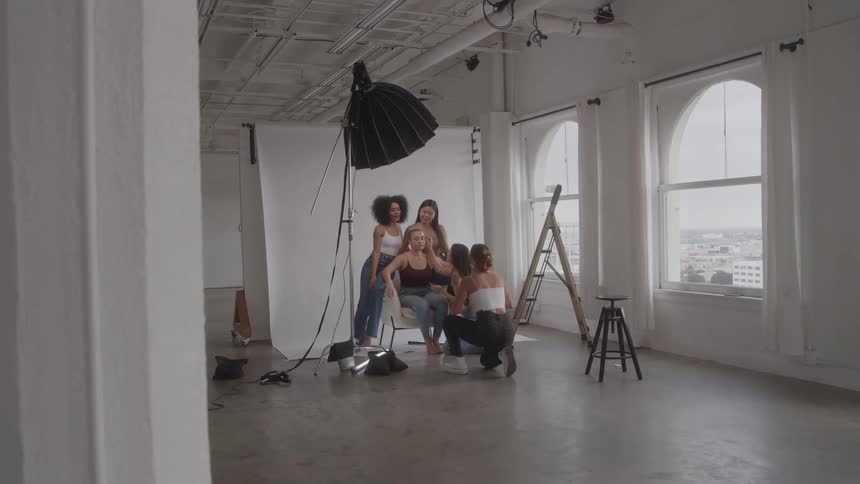 A group of people prepare for a photoshoot
