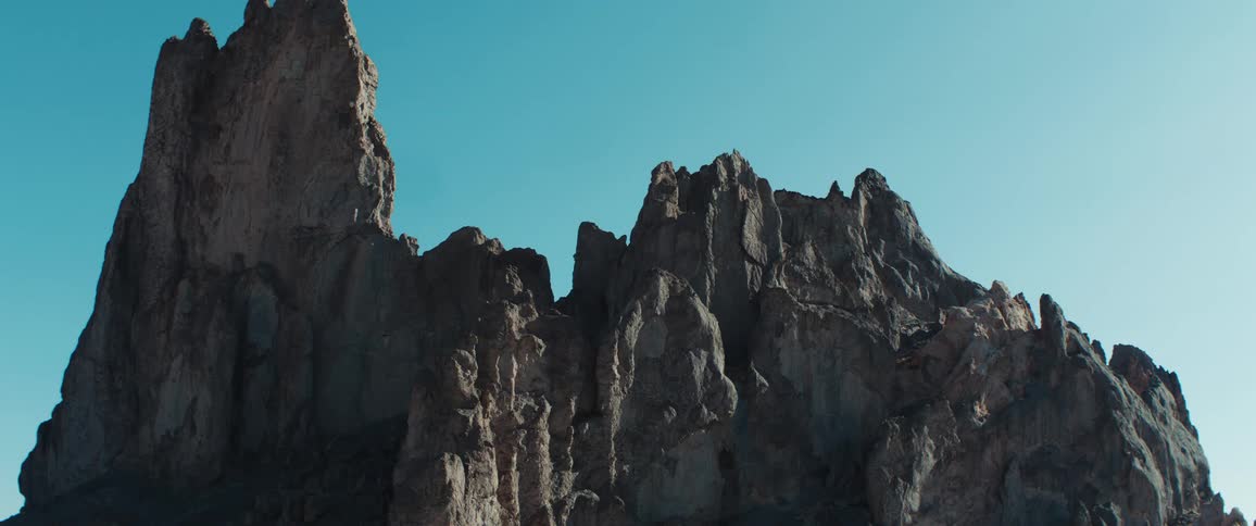 Rugged mountain peak rising under a clear blue sky