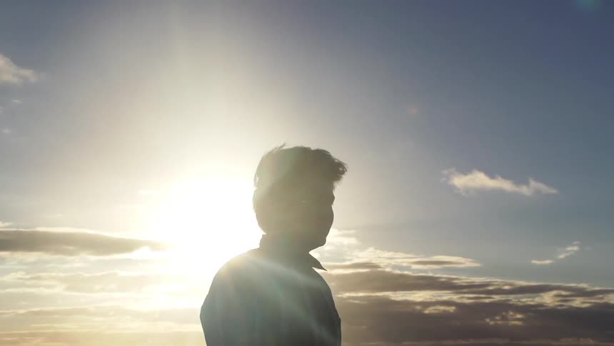Man on a beach at sunset