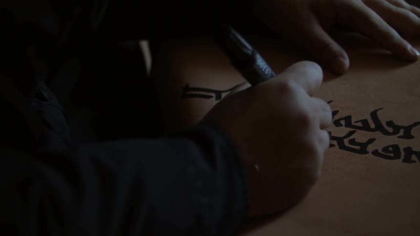 A man writes with a marker