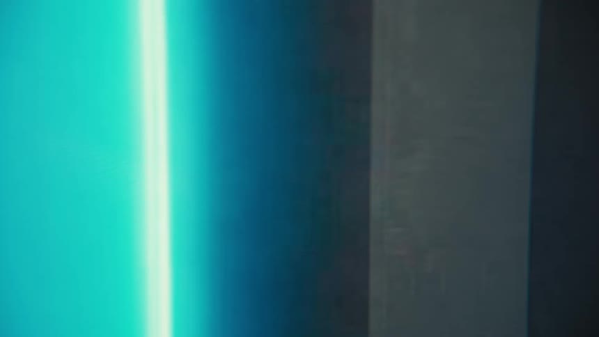 Closeup of a phone battery icon charging with a glowing blue indicator