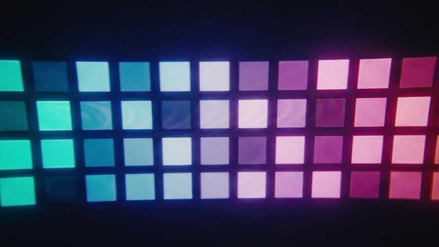 A dark video shows rows of glowing squares shifting in a gradient from bright green to blue and purple to pink on a screen