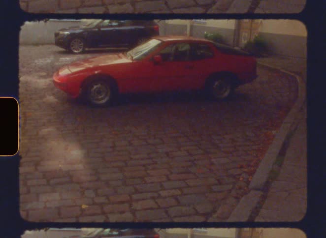 The first line shows a still image of a parked red car on a cobblestone street with another car partially visible behind it the second line shows a closeup of the film itself with a blue and red colored texture and the text filmsupply visible