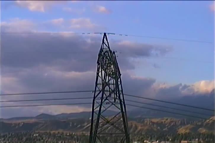 A high voltage cable tower on a field
